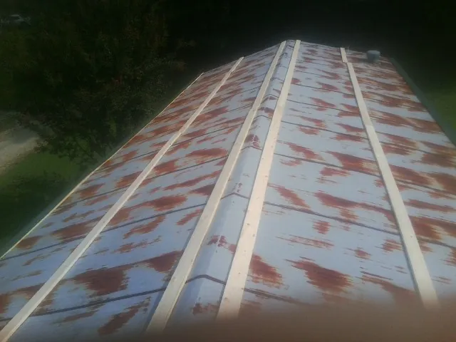 Rusted metal roof panels with new wood purlins before replacement — Storm Damage Roof Repair in Kirkwood by Roofing Brothers